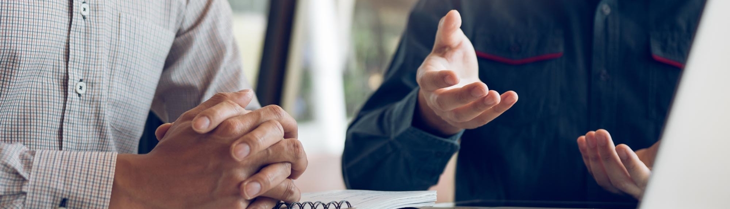 Side view of two people at a meeting